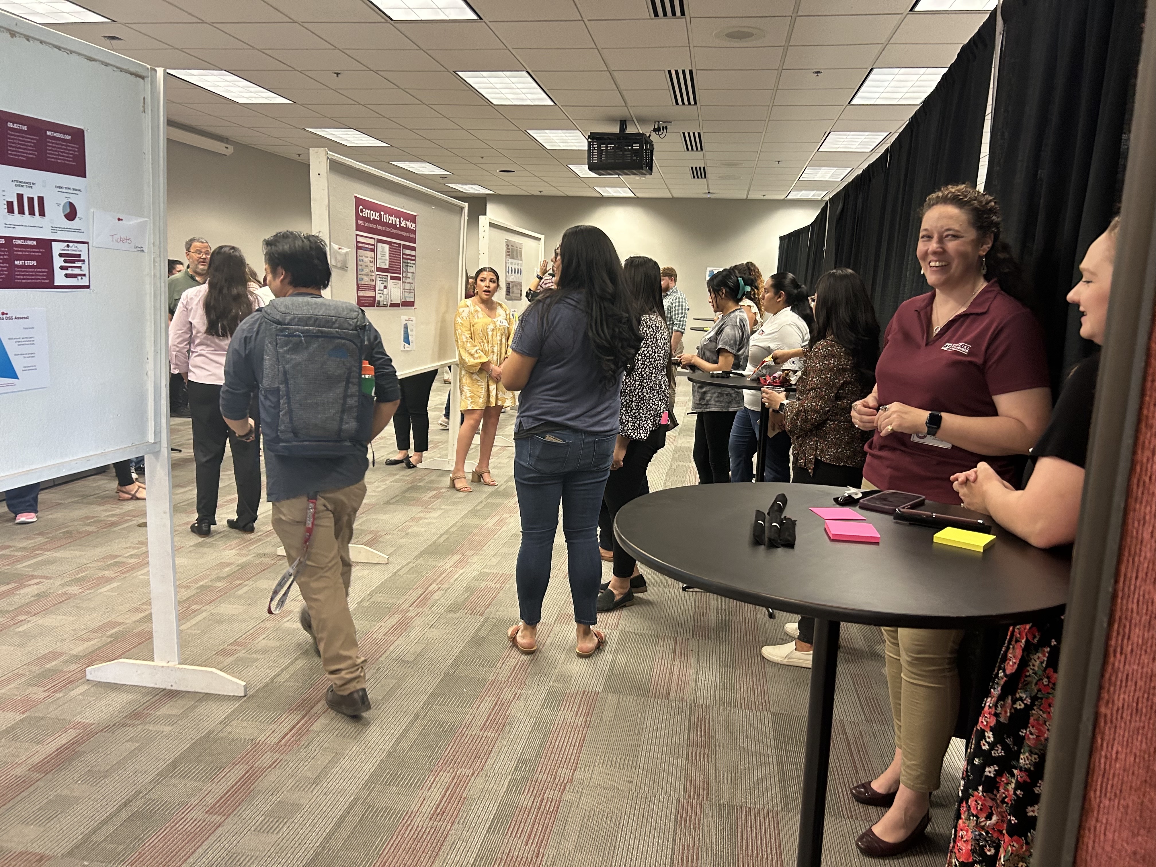 People interacting with poster presenters